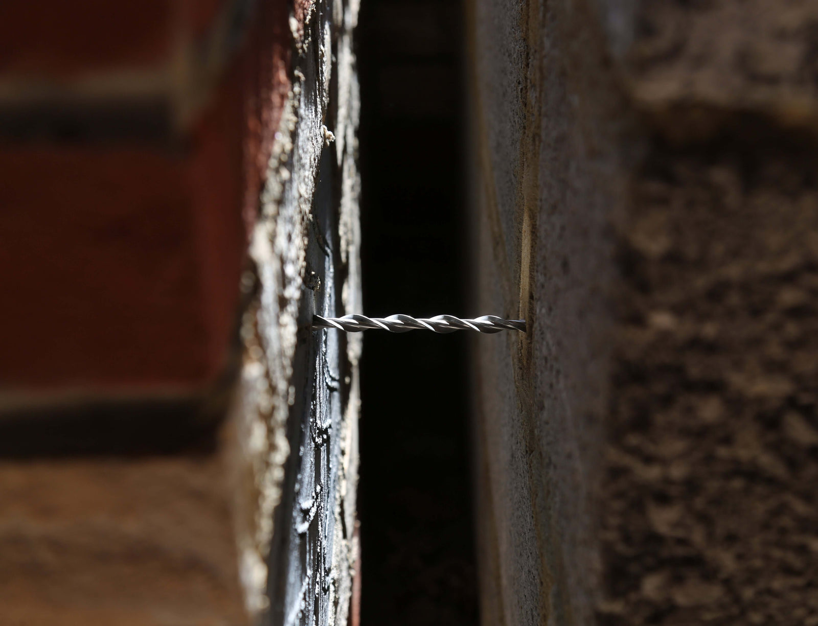 Wall tie in place in a wall