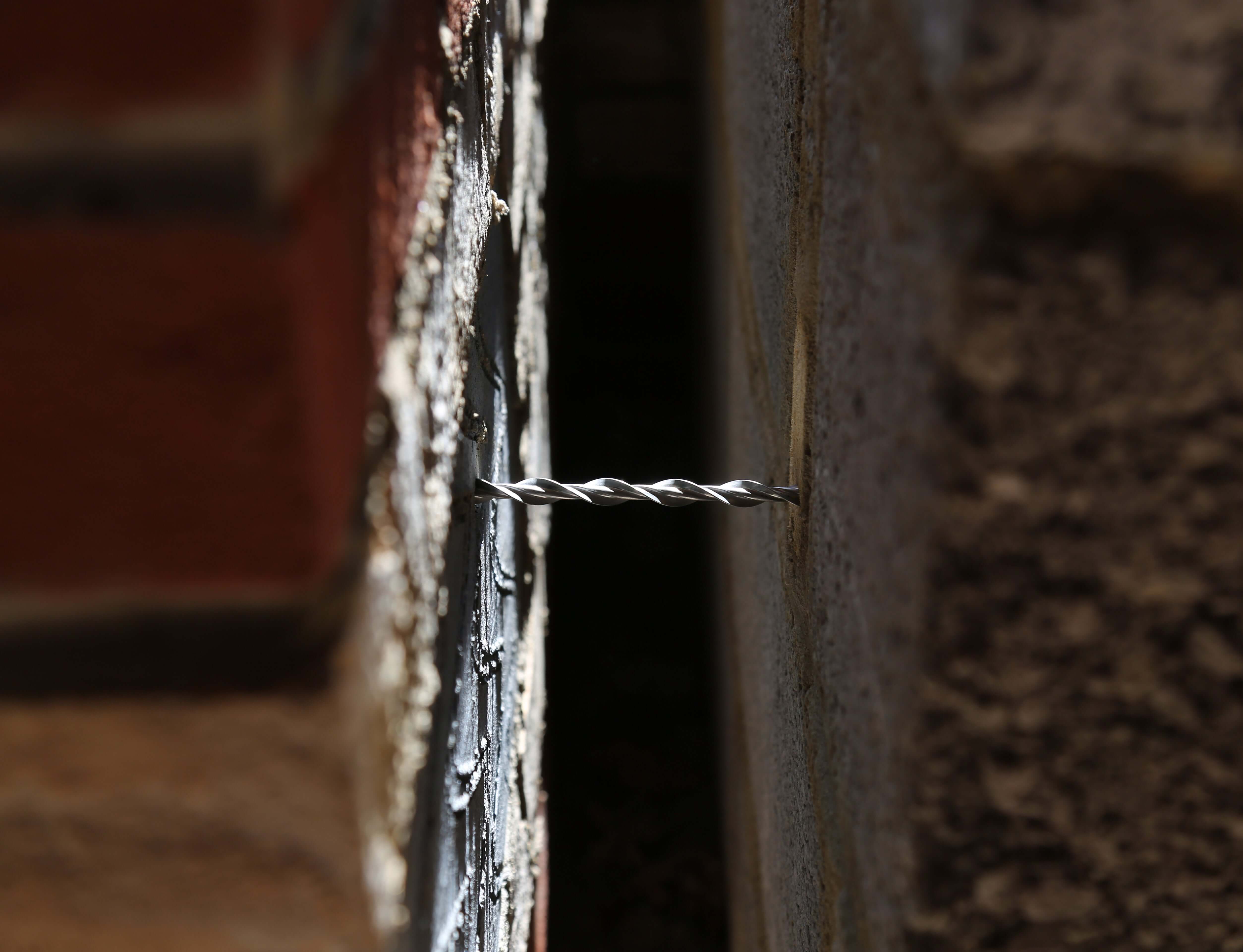 Wall tie in place in a wall