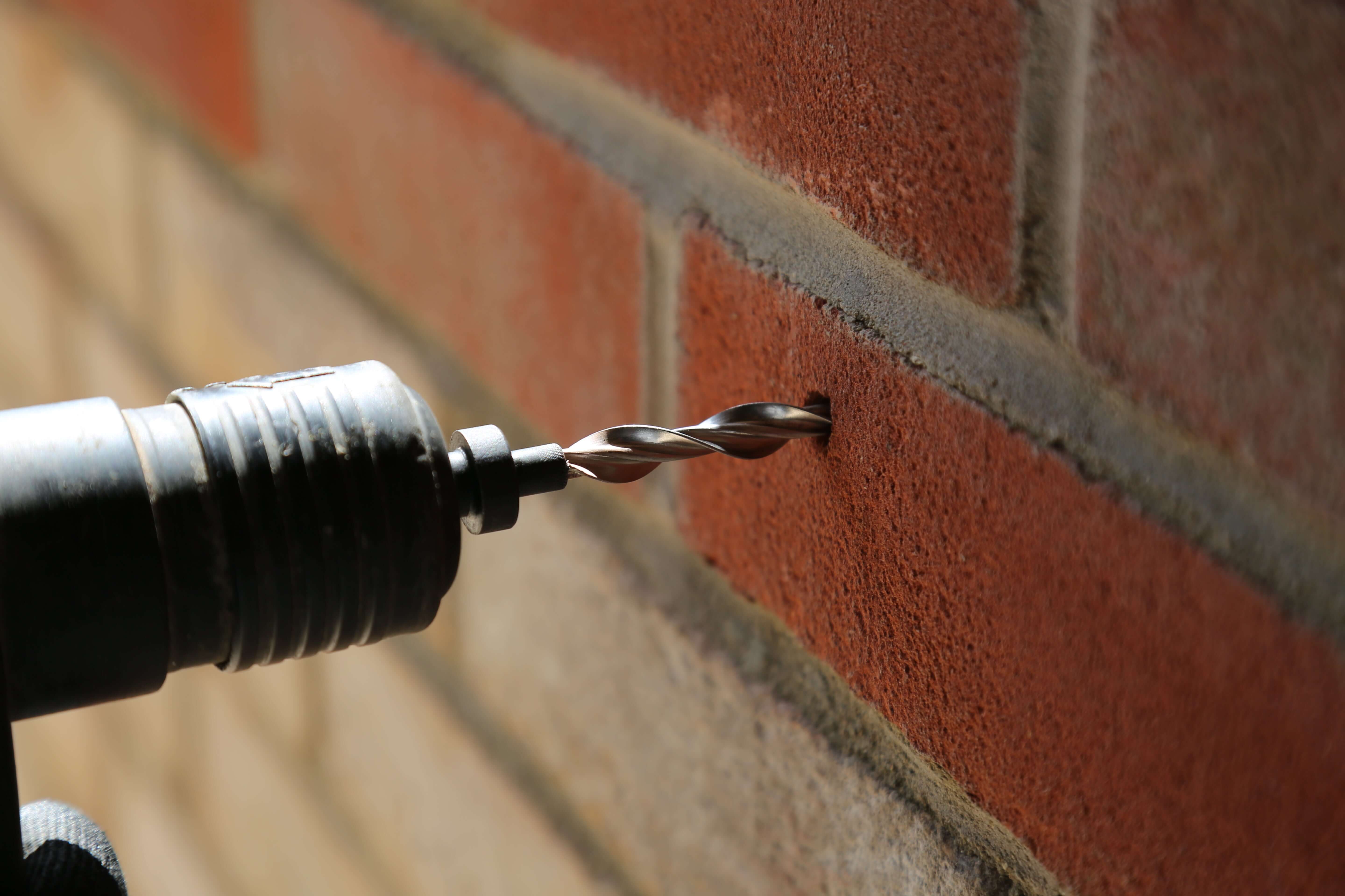 wall tie being installed into a wall