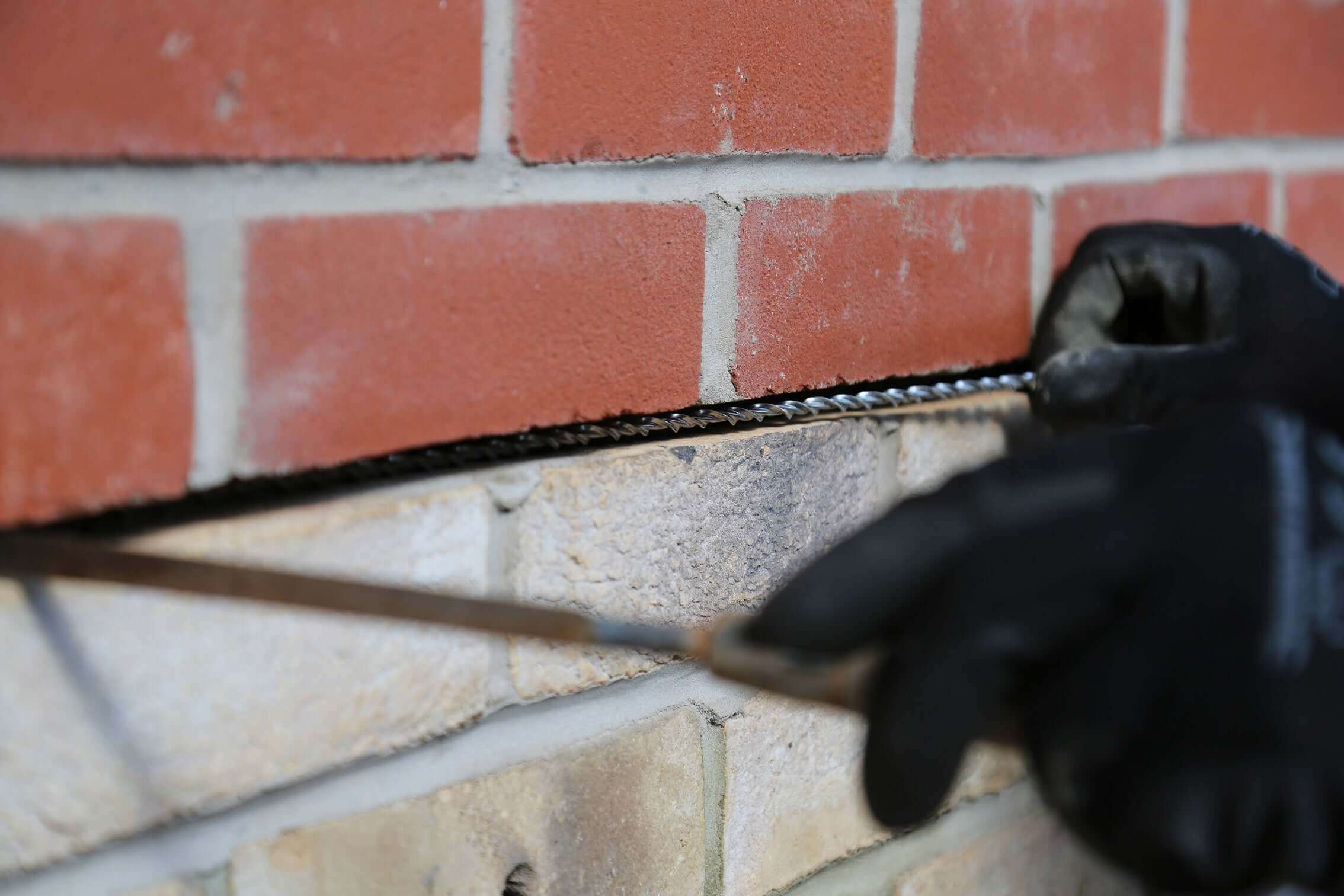 Repointing and finishing trowel for use in crack stitch repairs and repointing