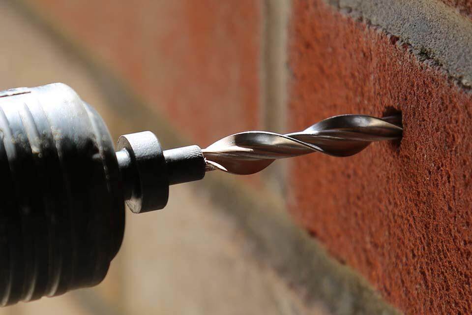 Wall tie being installed into a wall